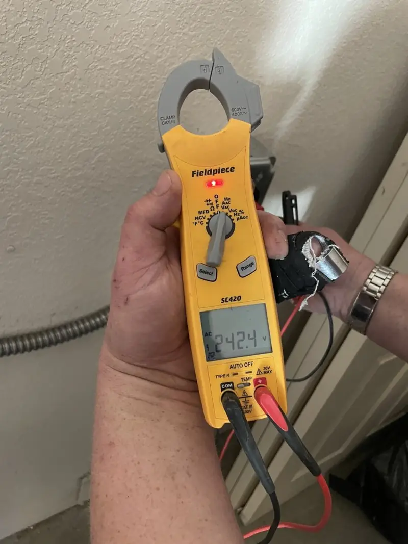 Voltage testing with clamp meter during Ceiling Fan Installation in Darien